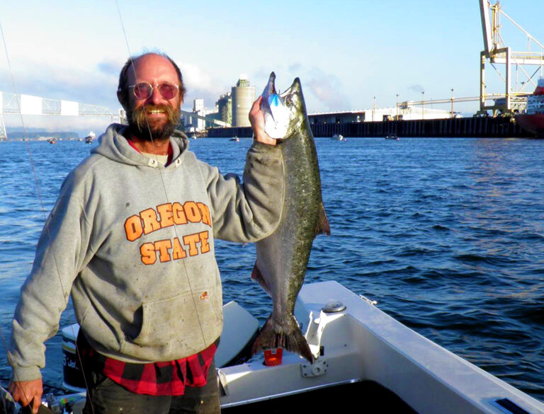 David D. Hunter, certified arborist, holding a very large fish that he caught on a boat